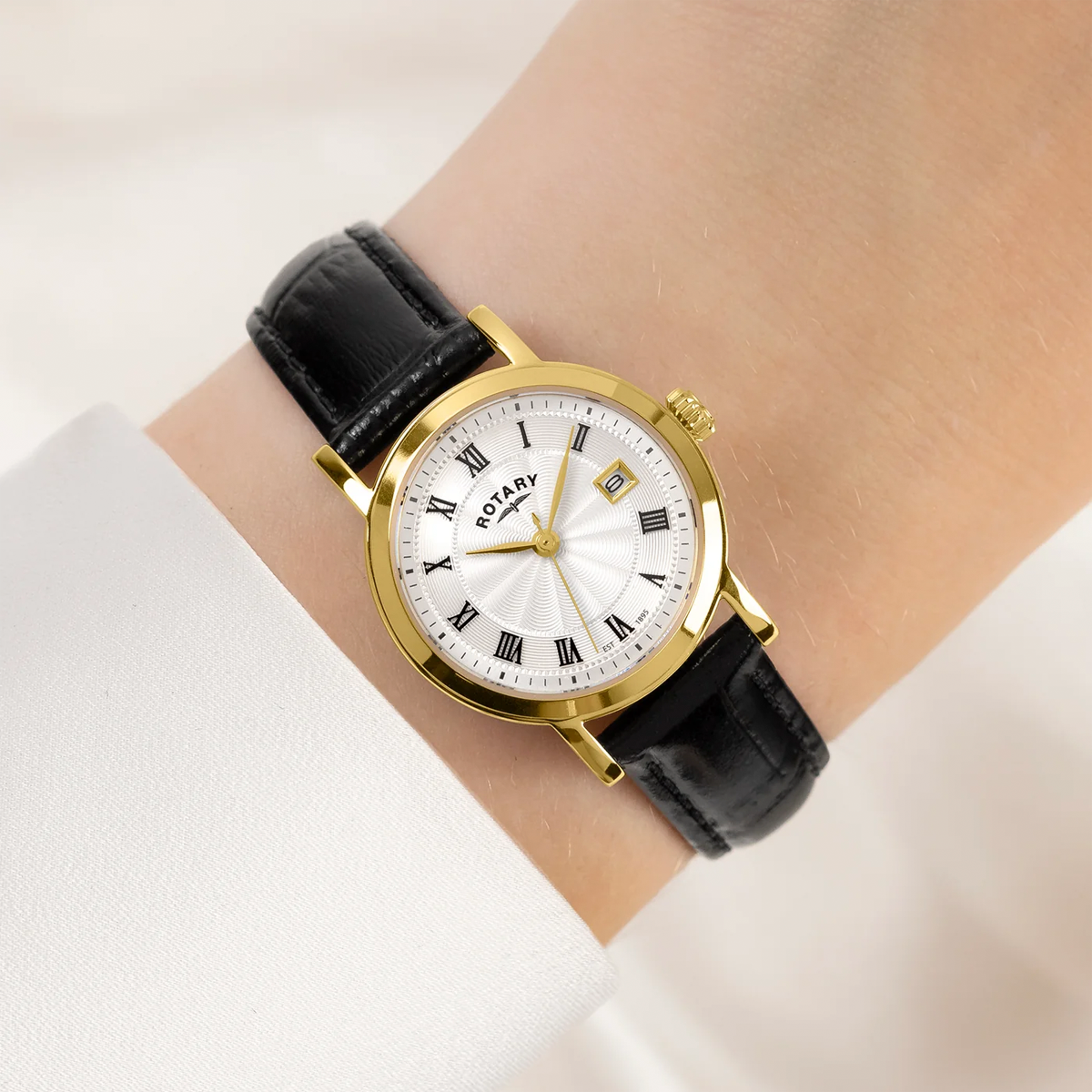 Model wears Rotary Heritage Ladies Gold Plated Watch, White Dial with Black Leather Strap - LS05423/01