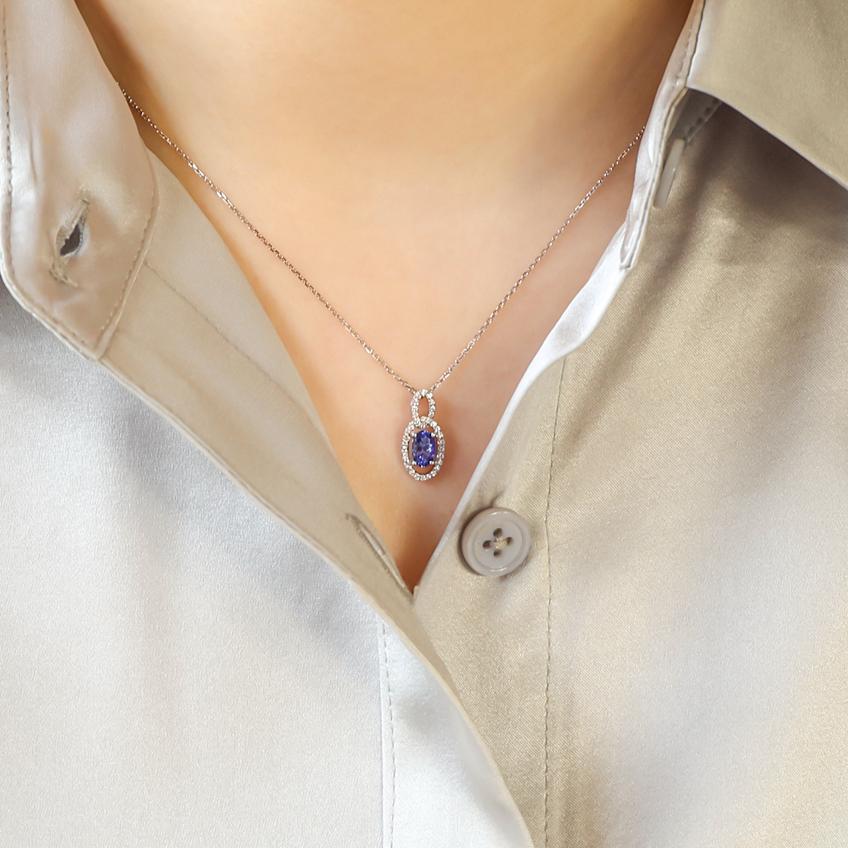 Model wears 9ct White Gold Tanzanite & Diamond Interlocking Halo Necklace