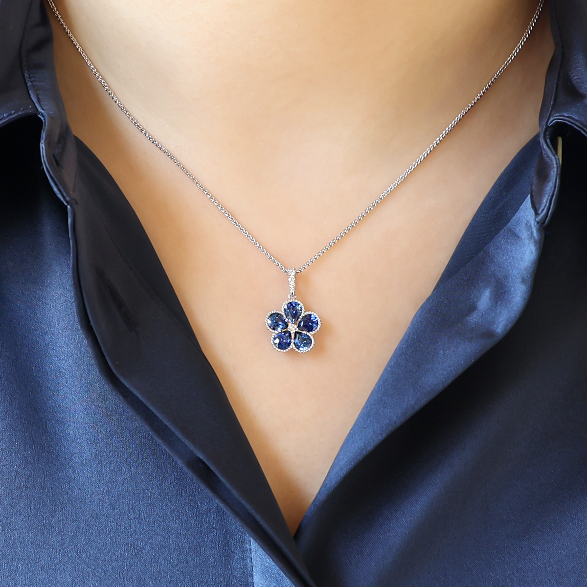 Model wears 18ct White Gold Sapphire & Diamond Flower Pendant & Chain