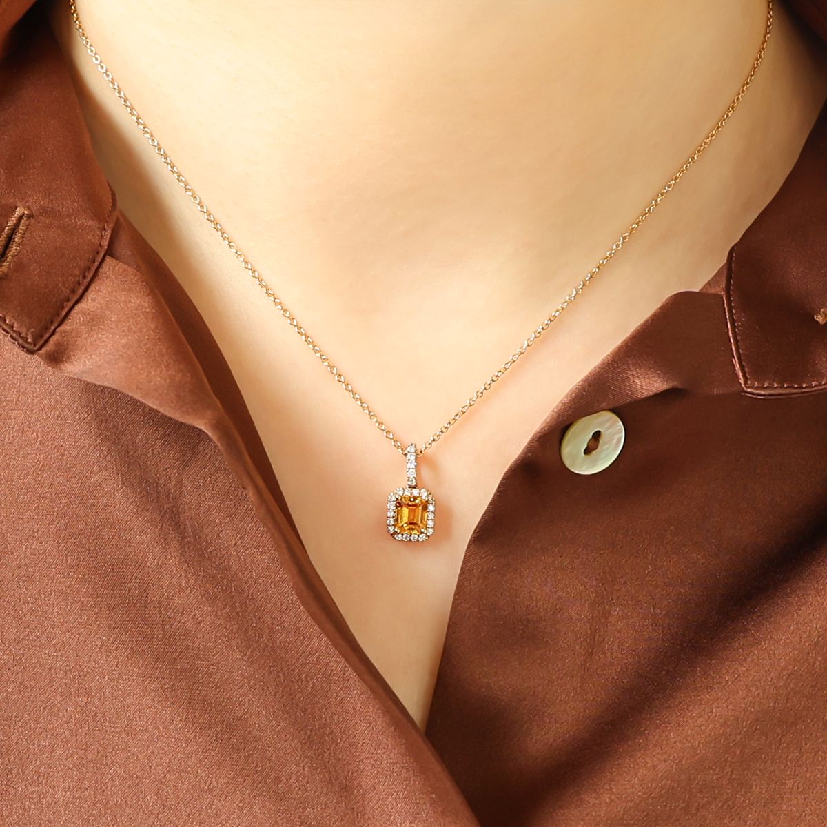 Model wears 18ct Yellow Gold Emerald Cut Yellow Sapphire & Diamond Halo Pendant & Chain