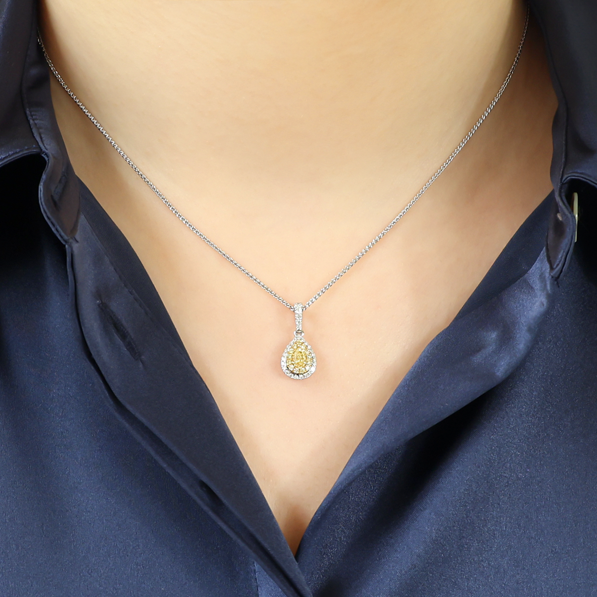 Model wears 18ct Yellow & White Gold Pear Shaped Fancy Yellow Diamond Double Halo Pendant & Chain