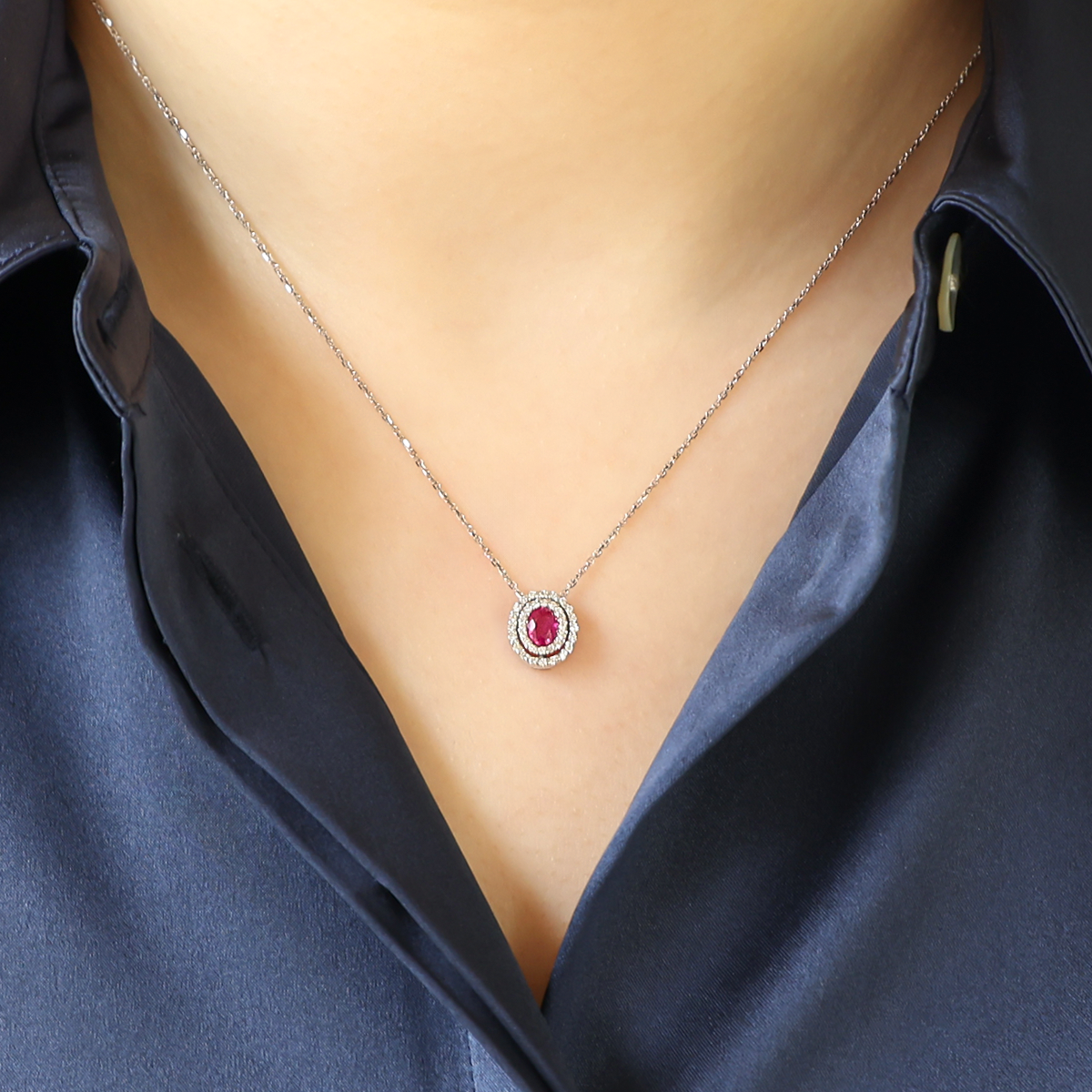 Model wears 9ct White Gold Oval Ruby & Diamond Double Halo Pendant & Chain