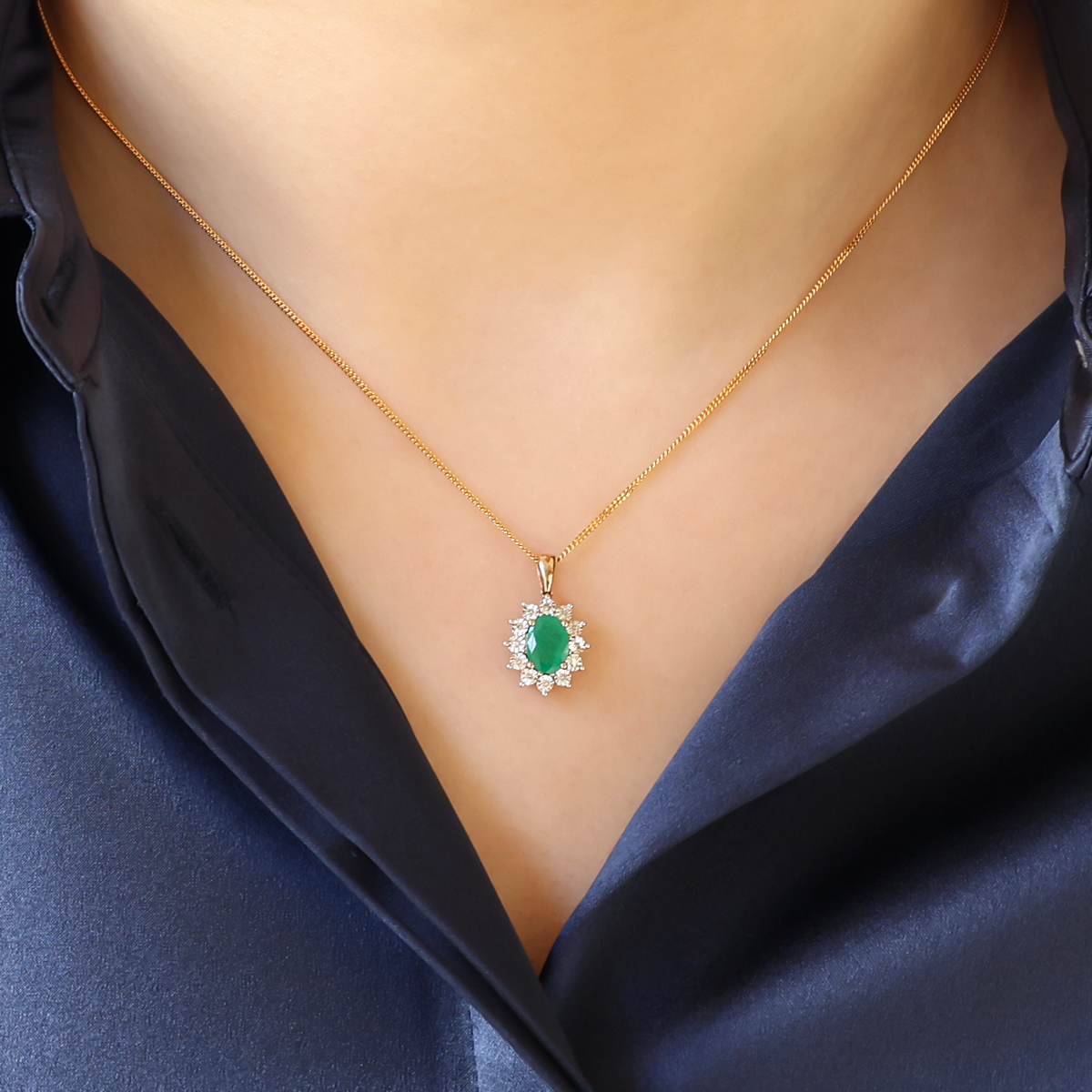 Model wears 9ct Yellow Gold Oval Shaped Emerald & Diamond Cluster Pendant