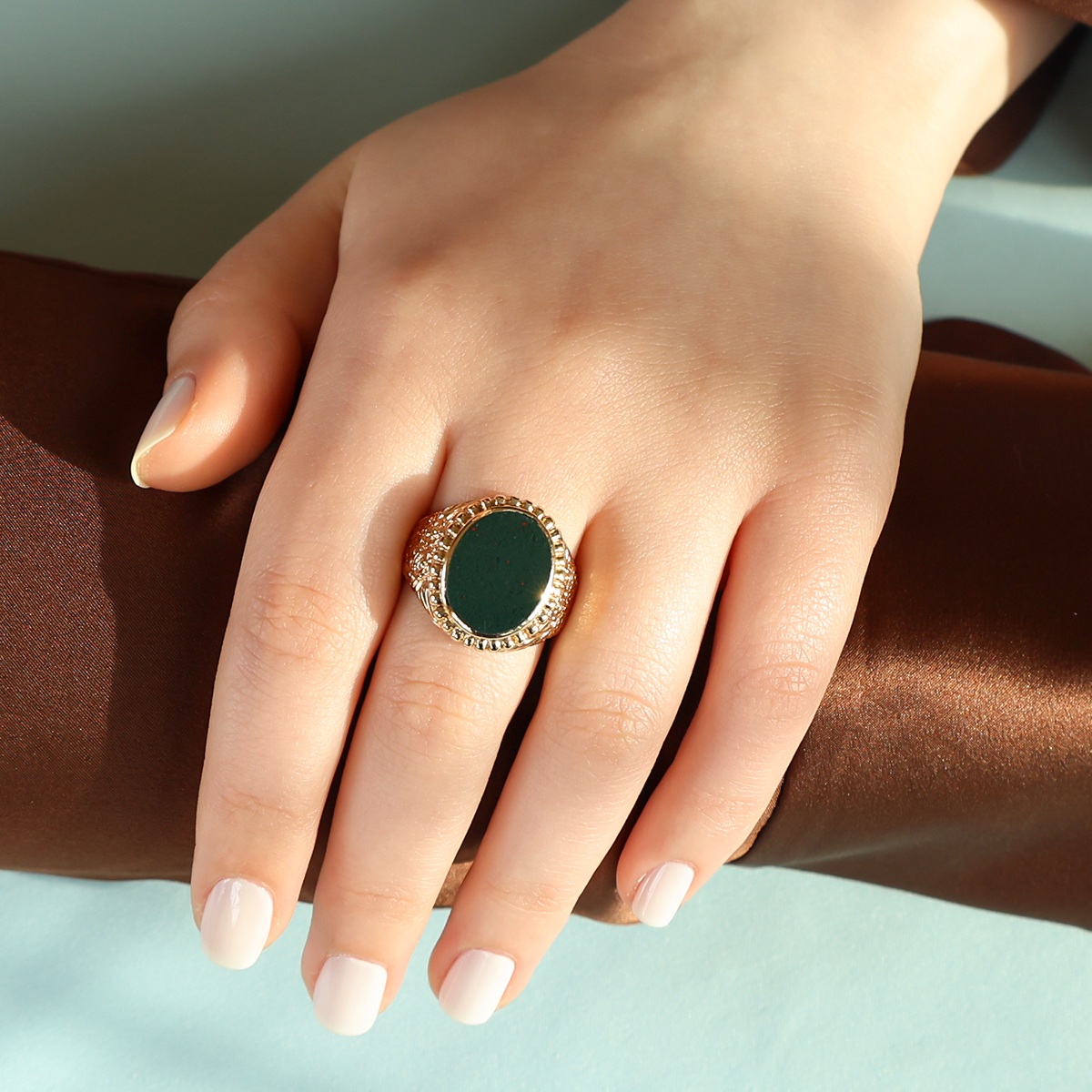 Model wears 9ct Yellow Gold Oval Shaped Bloodstone Engraved Signet Ring