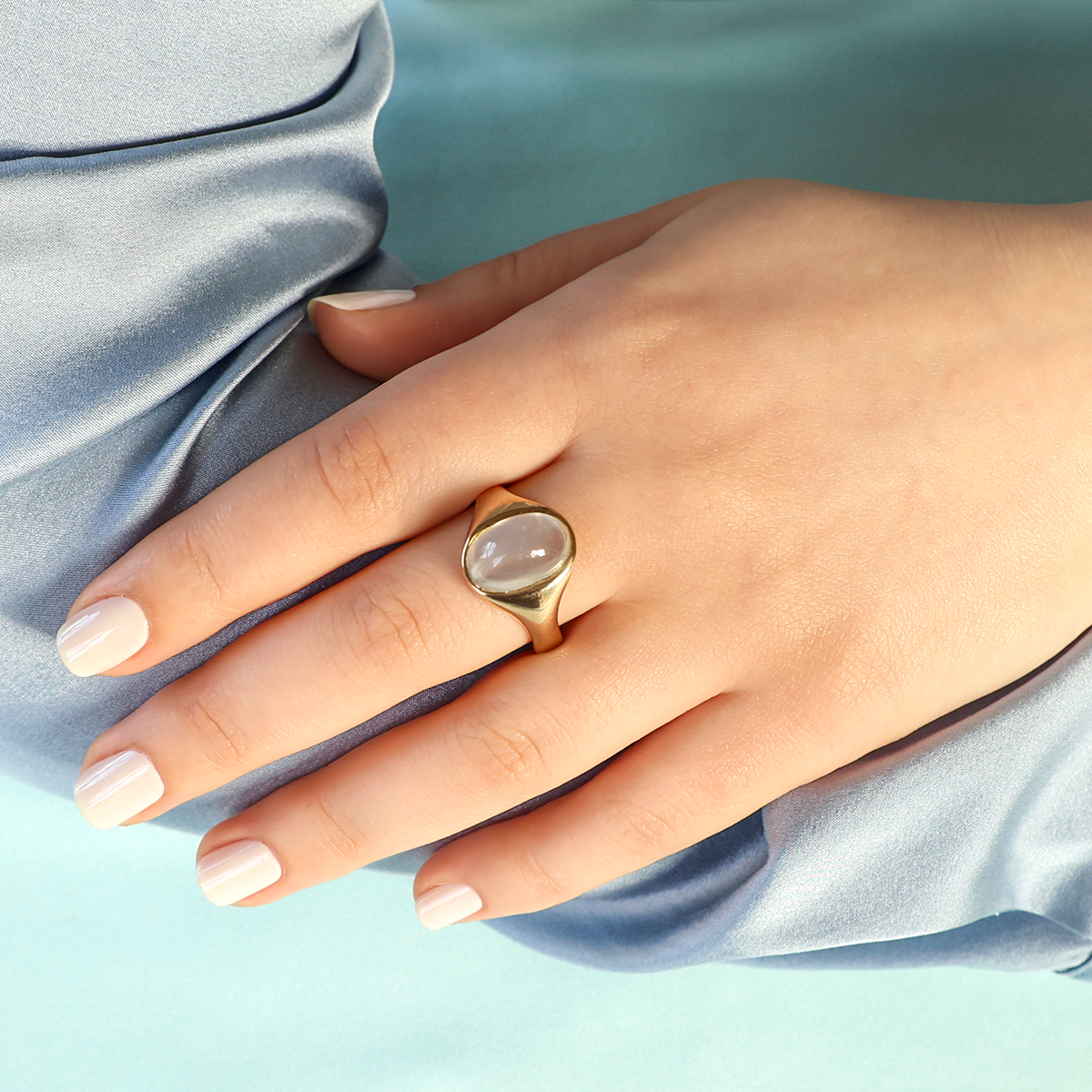Model wears Un-hallmarked 9ct Yellow Gold Moonstone Signet Ring