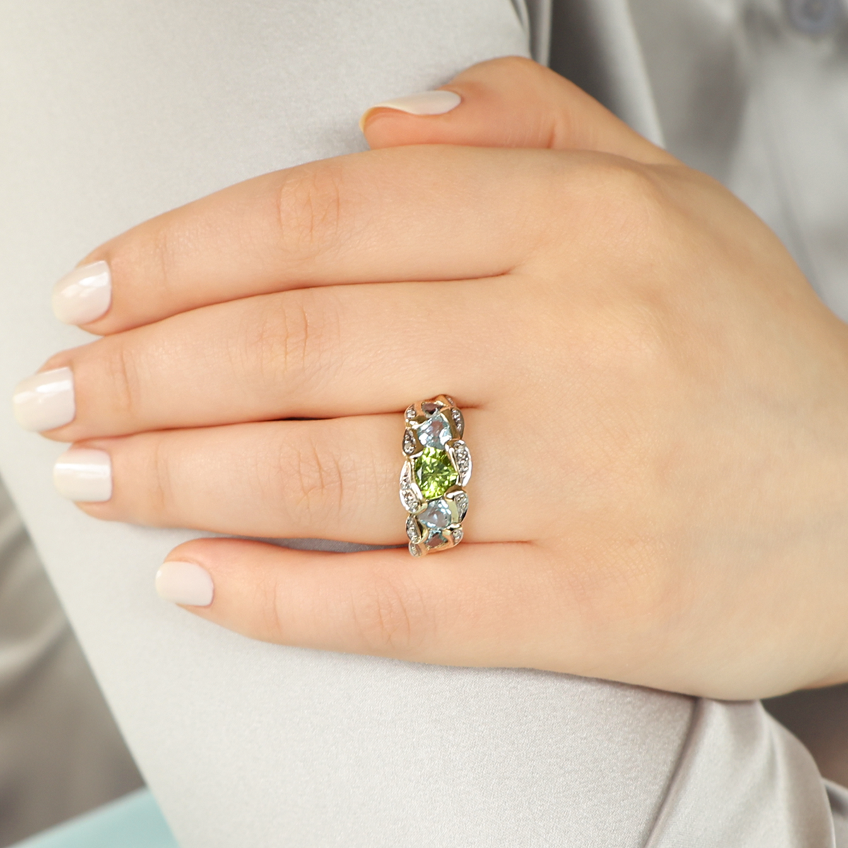 Model wears 9ct Yellow Gold Peridot, Blue Topaz & Diamond Dress Ring