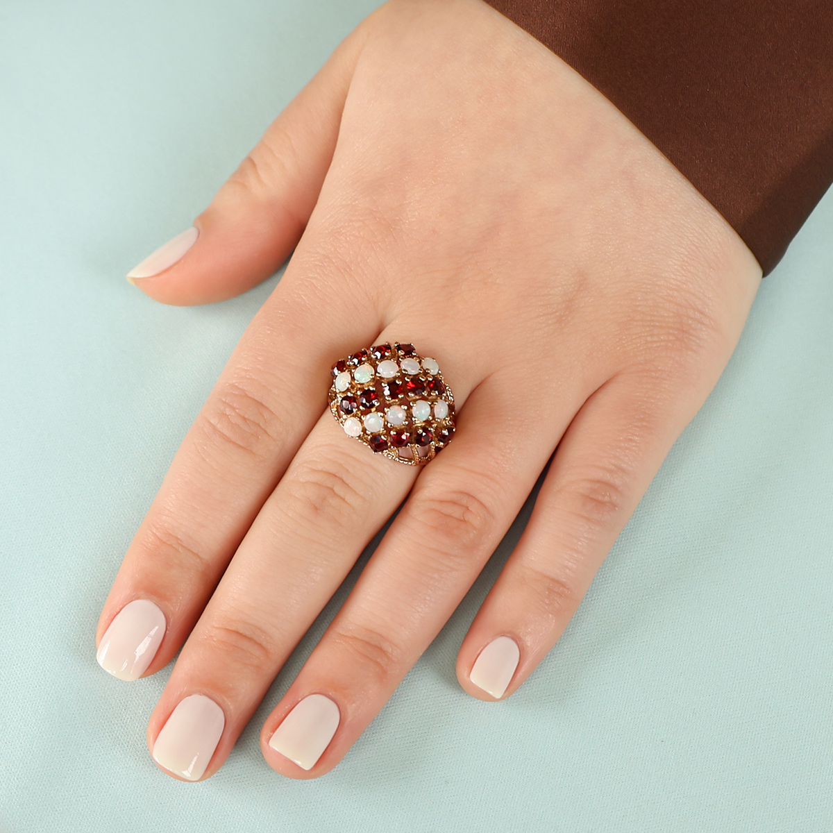 Model wears 9ct Yellow Gold Garnet & Opal Bombé Ring