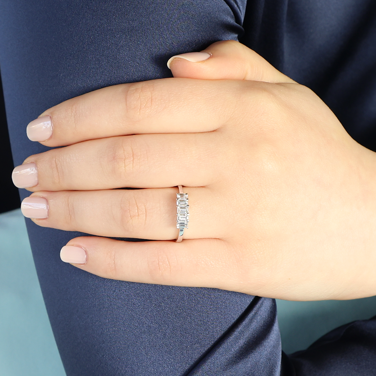 Model wears 18ct White Gold 0.67cts Emerald Cut Diamond Five Stone Ring