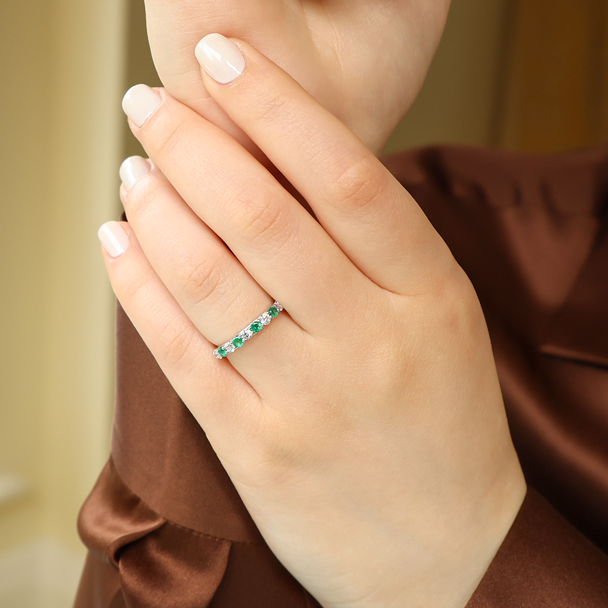 Model wears 18ct White Gold Emerald & 0.41cts Diamond Claw Set Eternity Ring