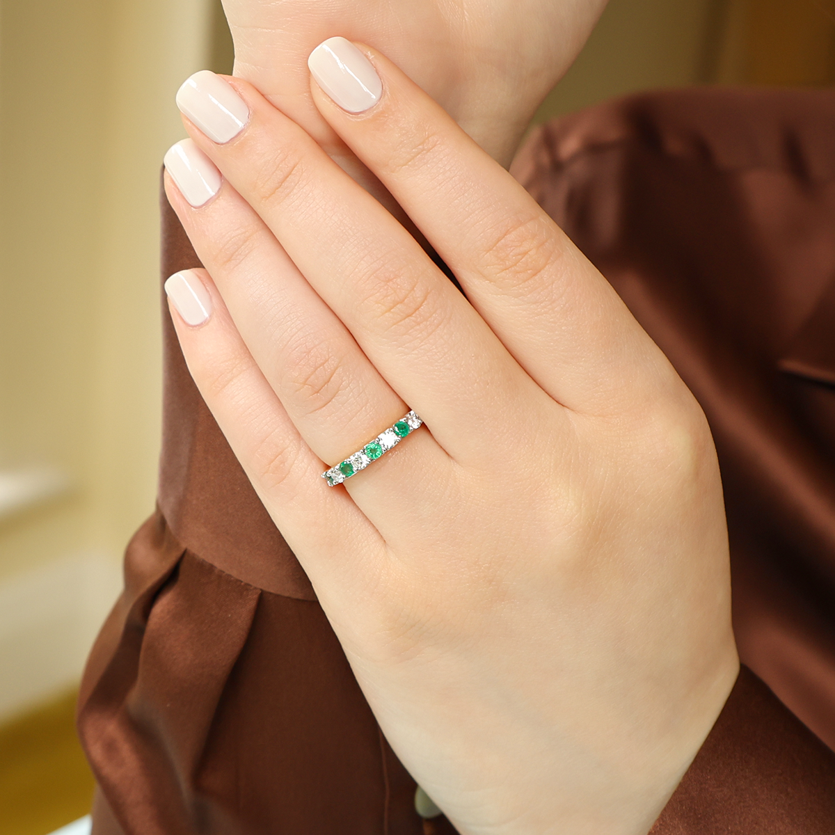 Model wears 18ct Yellow Gold 0.54cts Diamond & Emerald Claw Set Eternity Ring
