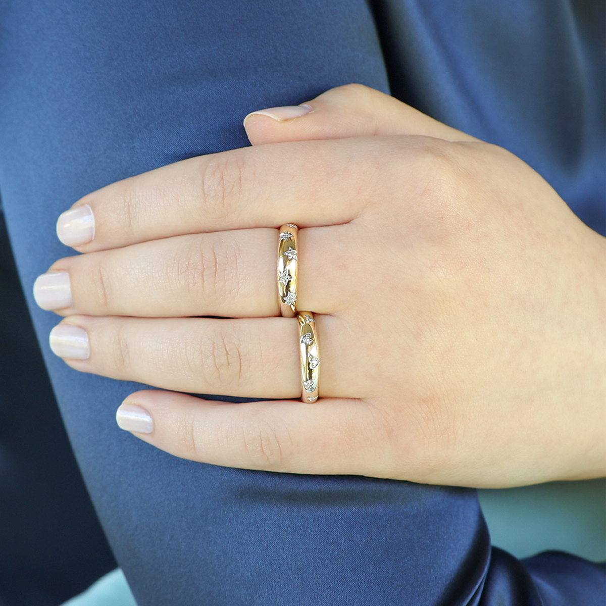Model wears 9ct Yellow Gold Diamond Set Hearts Ring & 9ct Yellow Gold Diamond Set Stars Ring