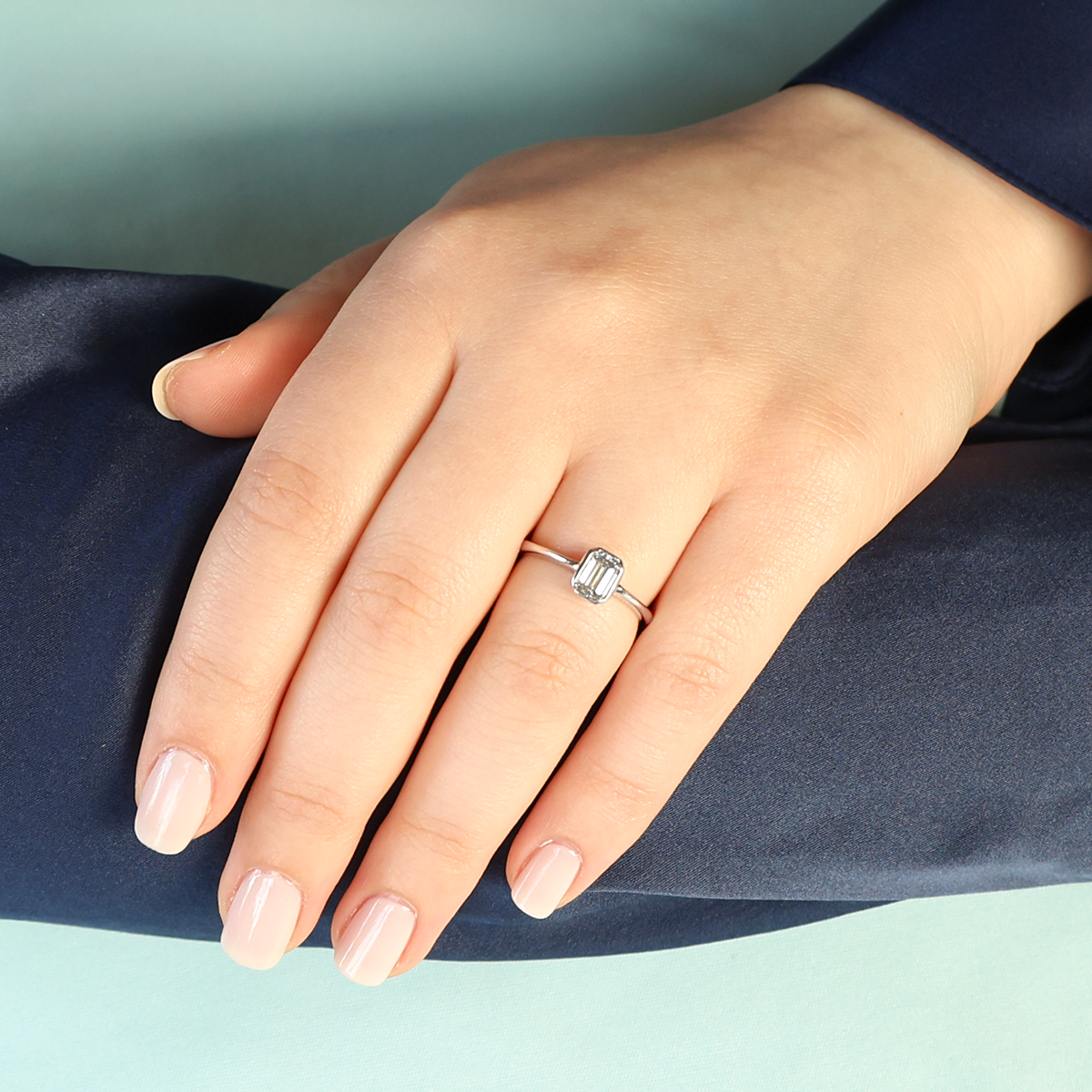 Model wears 18ct White Gold Emerald Cut 0.60ct Diamond Solitaire Ring