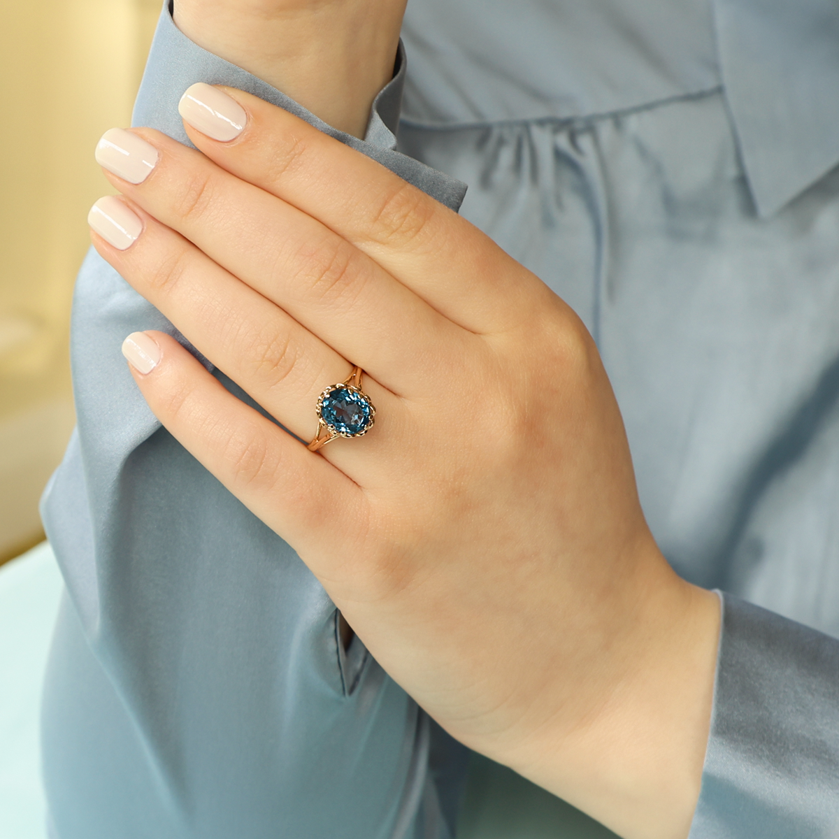 Model wears 9ct Yellow Gold Synthetic Blue Spinel Lotus Ring