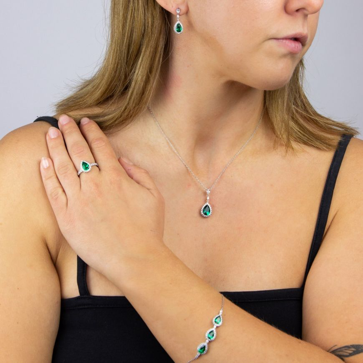 Model wears Sterling Silver Green Cubic Zirconia Teardrop with Pave Surround Necklace, Earrings, Ring & Bracelet