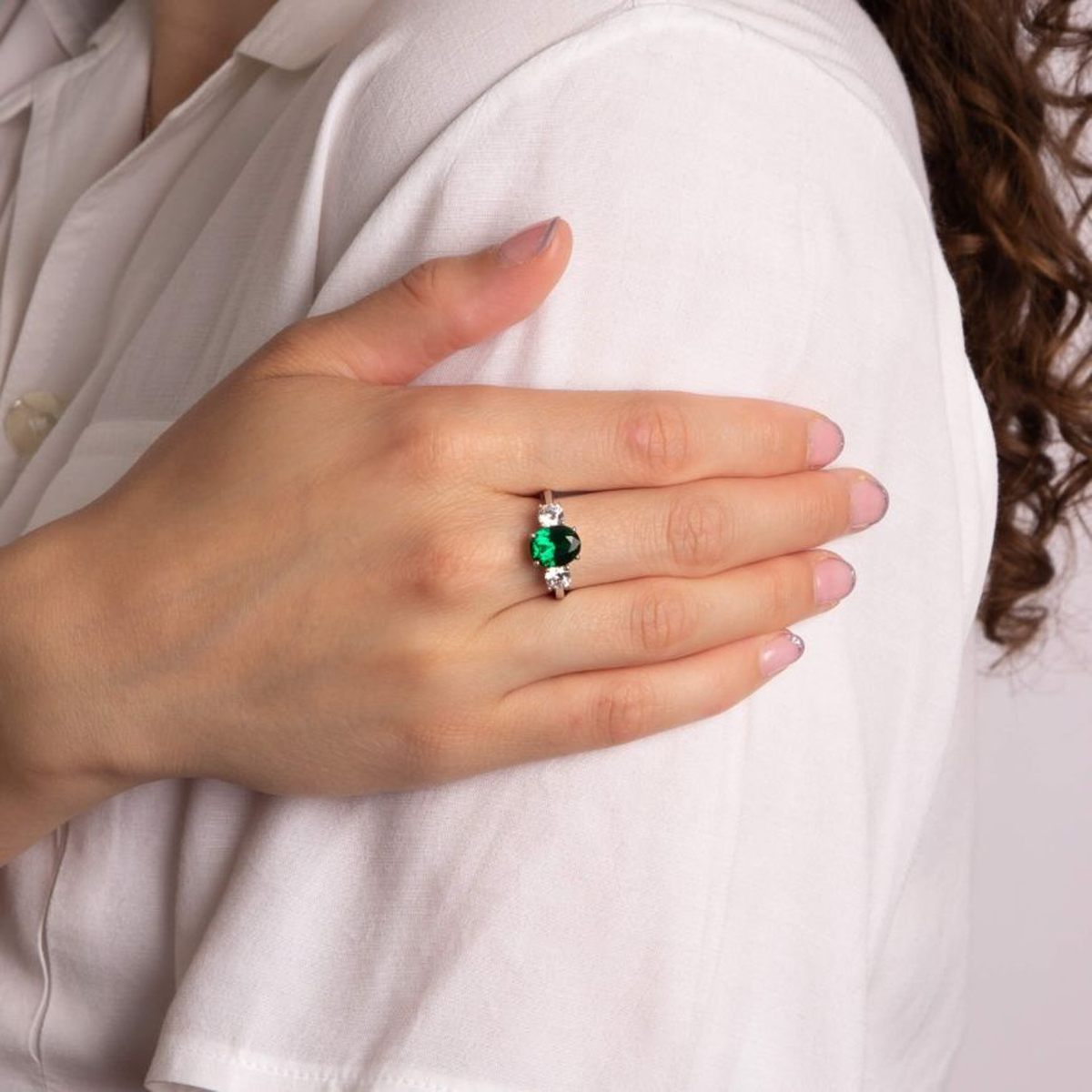 Model wears Sterling Silver Oval Green Cubic Zirconia Trilogy Ring