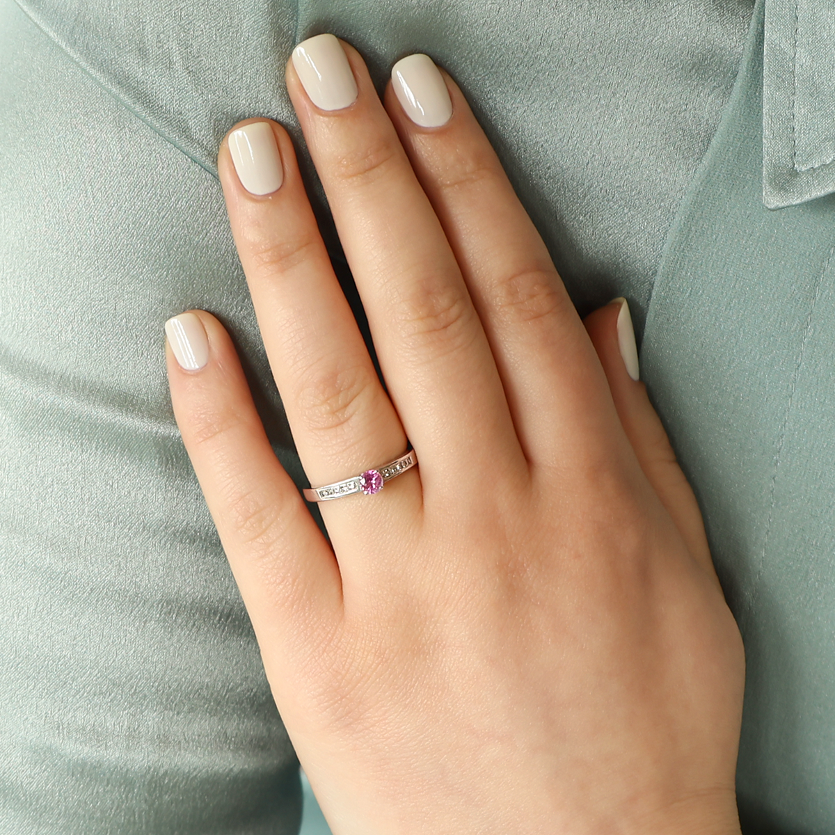 Model wears 18ct White Gold Pink Sapphire & Diamond Channel Set Shoulders Solitaire Ring