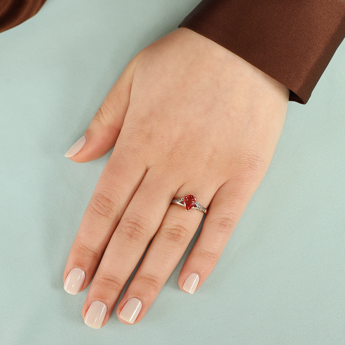 Model wears 9ct Yellow Gold Pear Shaped Orange Sapphire & Diamond Ring