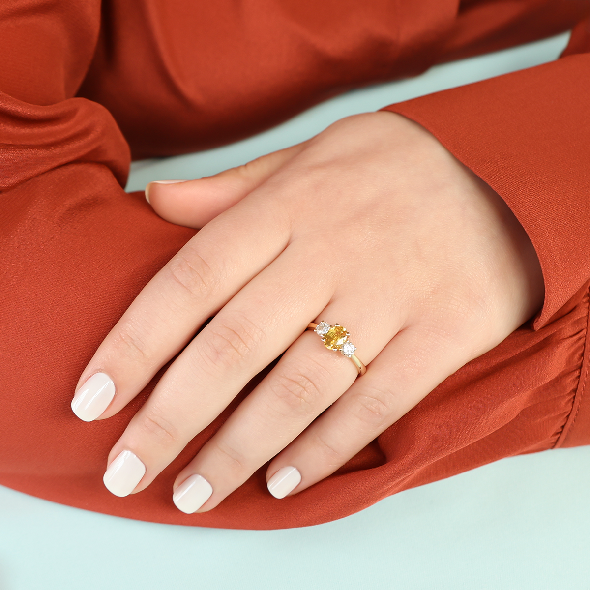 Model wears 18ct Yellow Gold Oval Shaped Yellow Sapphire & Diamond Trilogy Ring