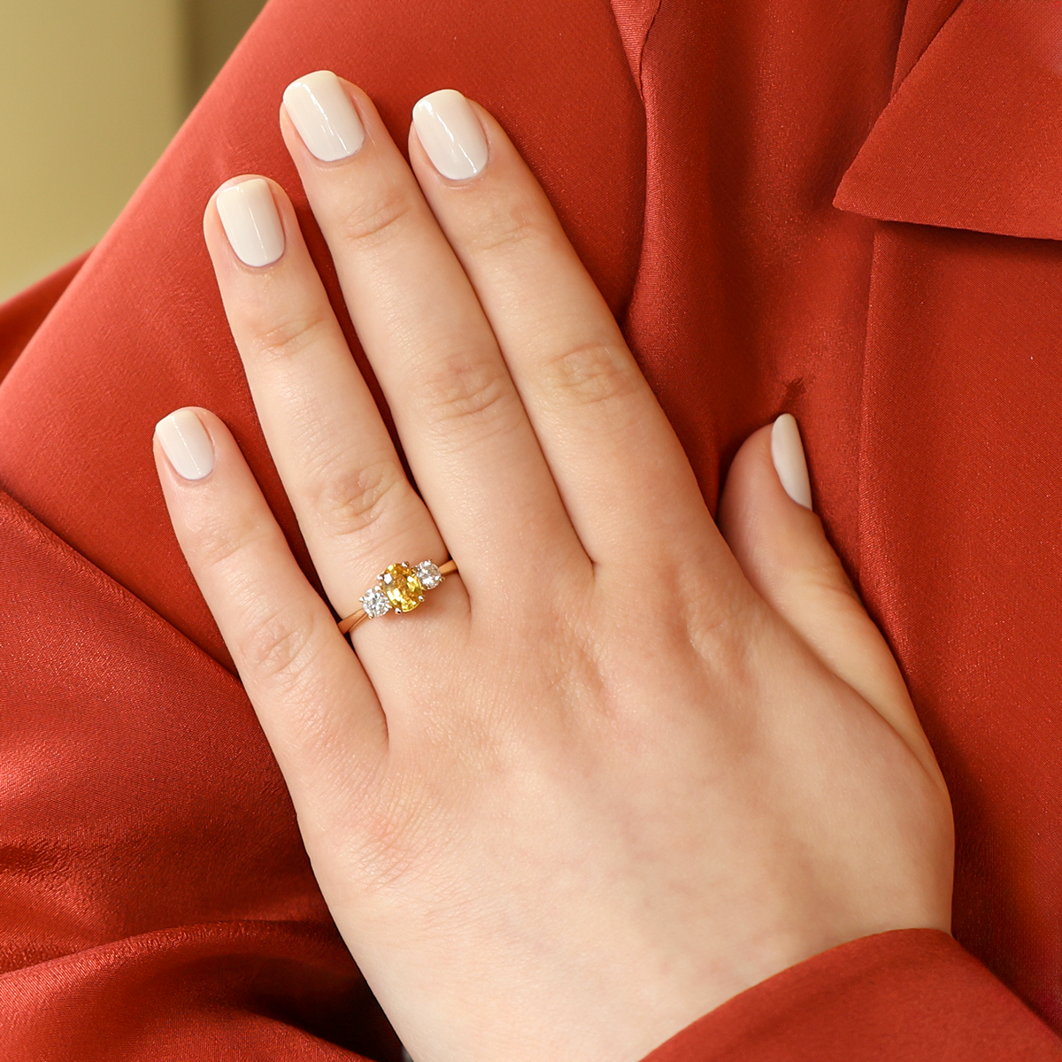 Model wears 18ct Yellow Gold Oval Shaped Yellow Sapphire & Diamond Trilogy Ring