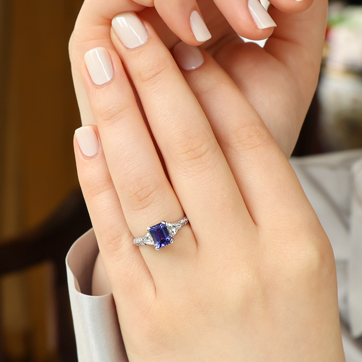 Model wears Platinum Emerald Cut Certified 1.32ct Tanzanite & Diamond Trilogy Ring