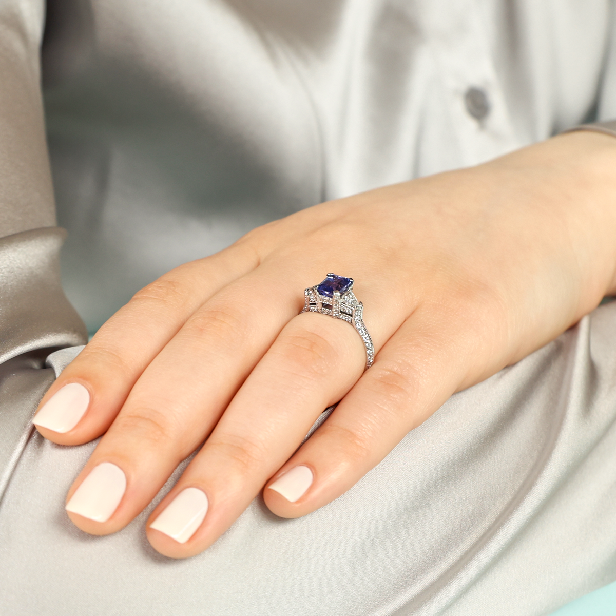 Model wears Platinum Emerald Cut Certified 1.32ct Tanzanite & Diamond Trilogy Ring