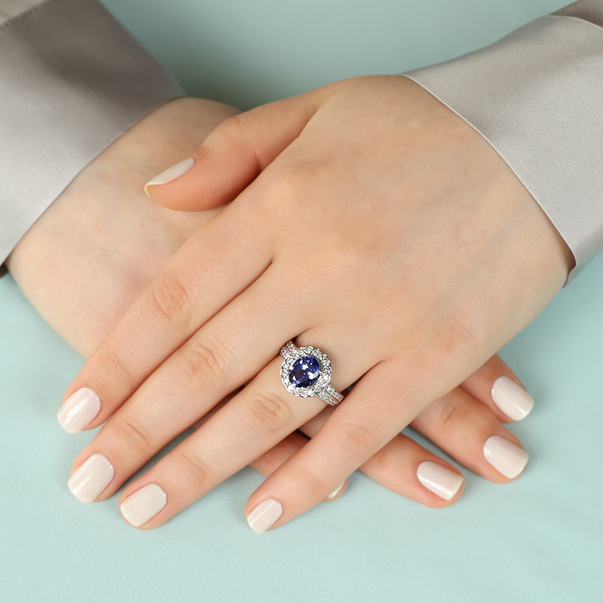 Model wears 14ct White Gold Oval Shaped Tanzanite & Diamond Cluster Ring