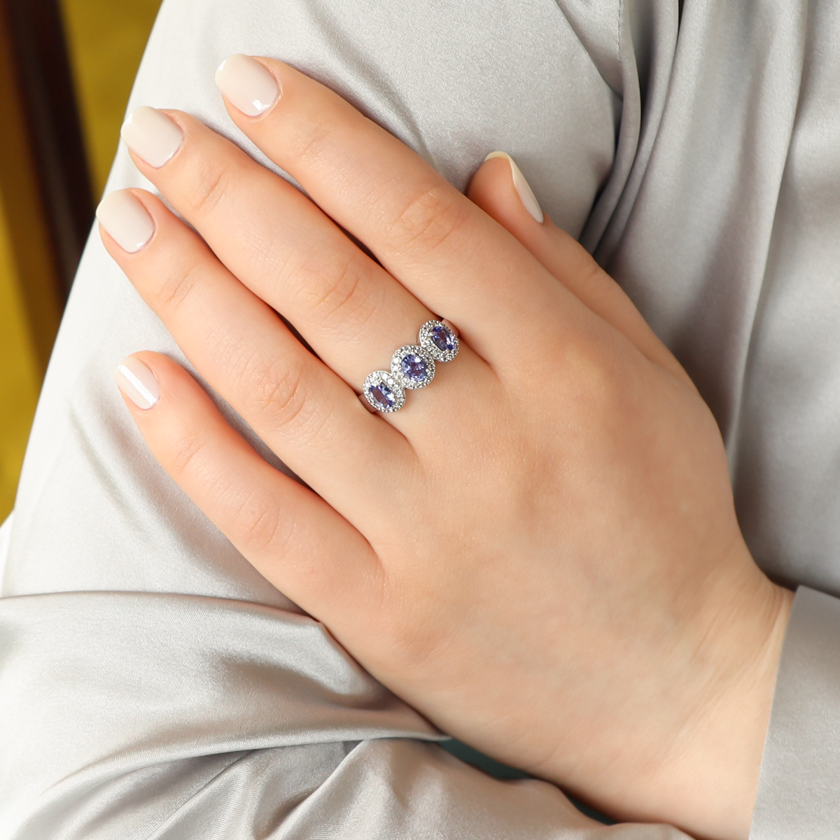 Model wears 18ct White Gold Tanzanite & Diamond Triple Cluster Ring