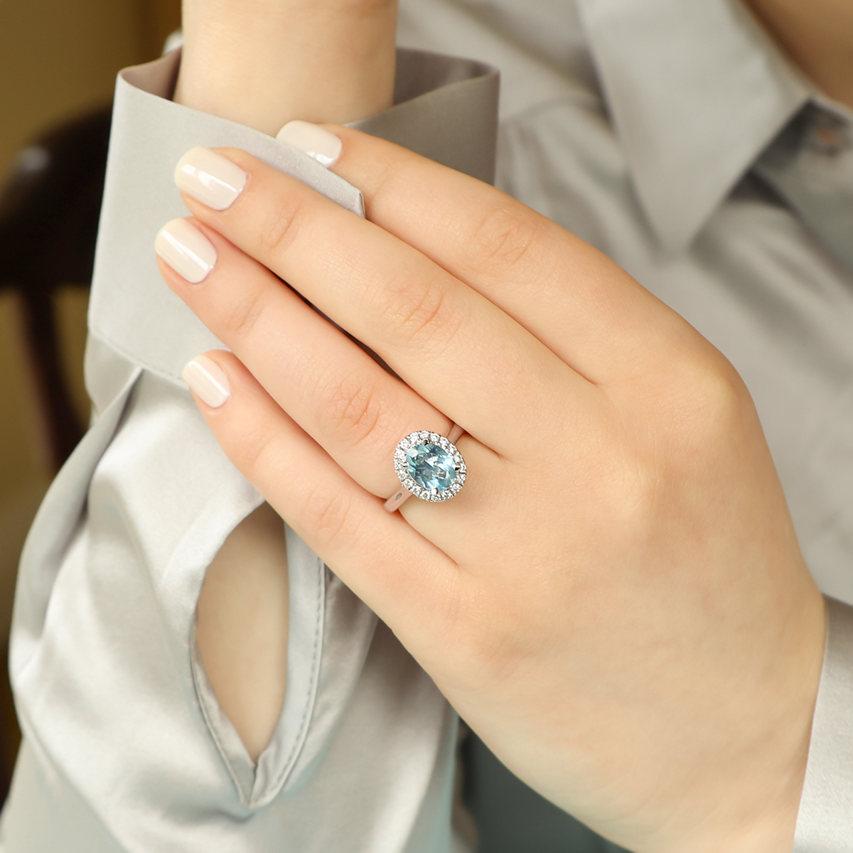 Model wears 18ct White Gold Oval Shaped Aquamarine & Diamond Cluster Ring