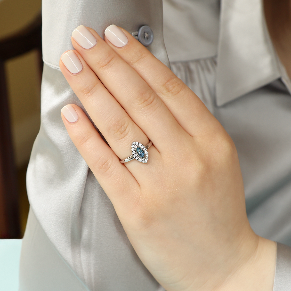 Model wears 18ct White Gold Marquise Shaped Aquamarine & Diamond Cluster Ring