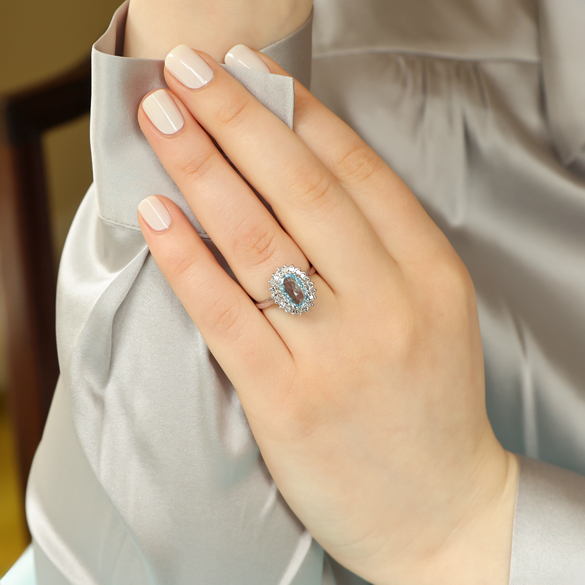 Model wears 18ct White Gold Oval Cut Aquamarine & Diamond Cluster Ring