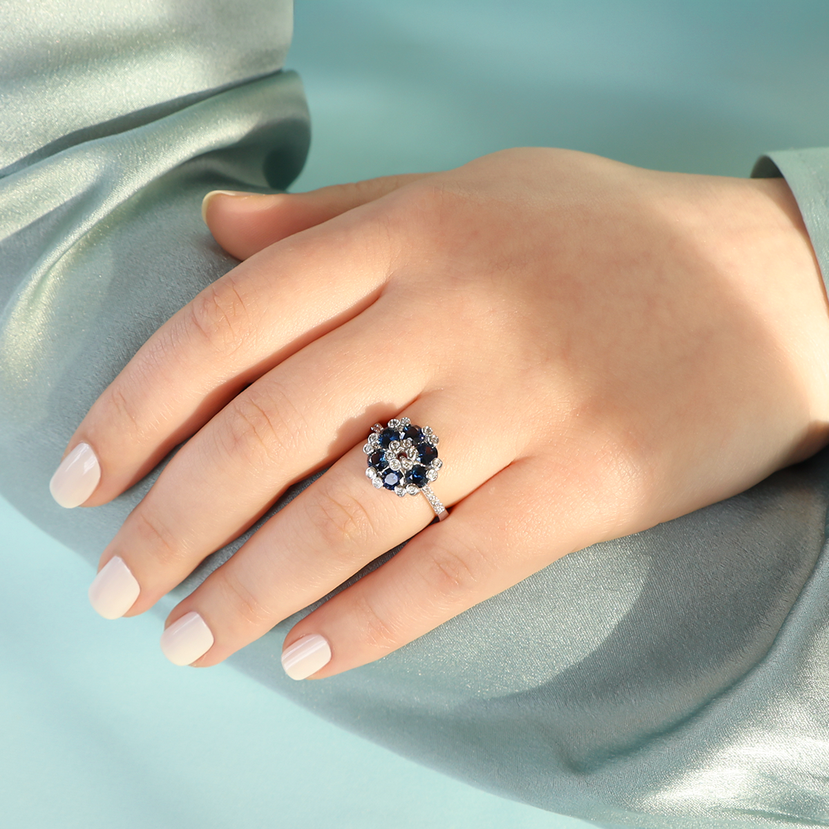 Model wears 18ct White Gold Sapphire & Diamond Cluster With Diamond Set Shoulders Ring