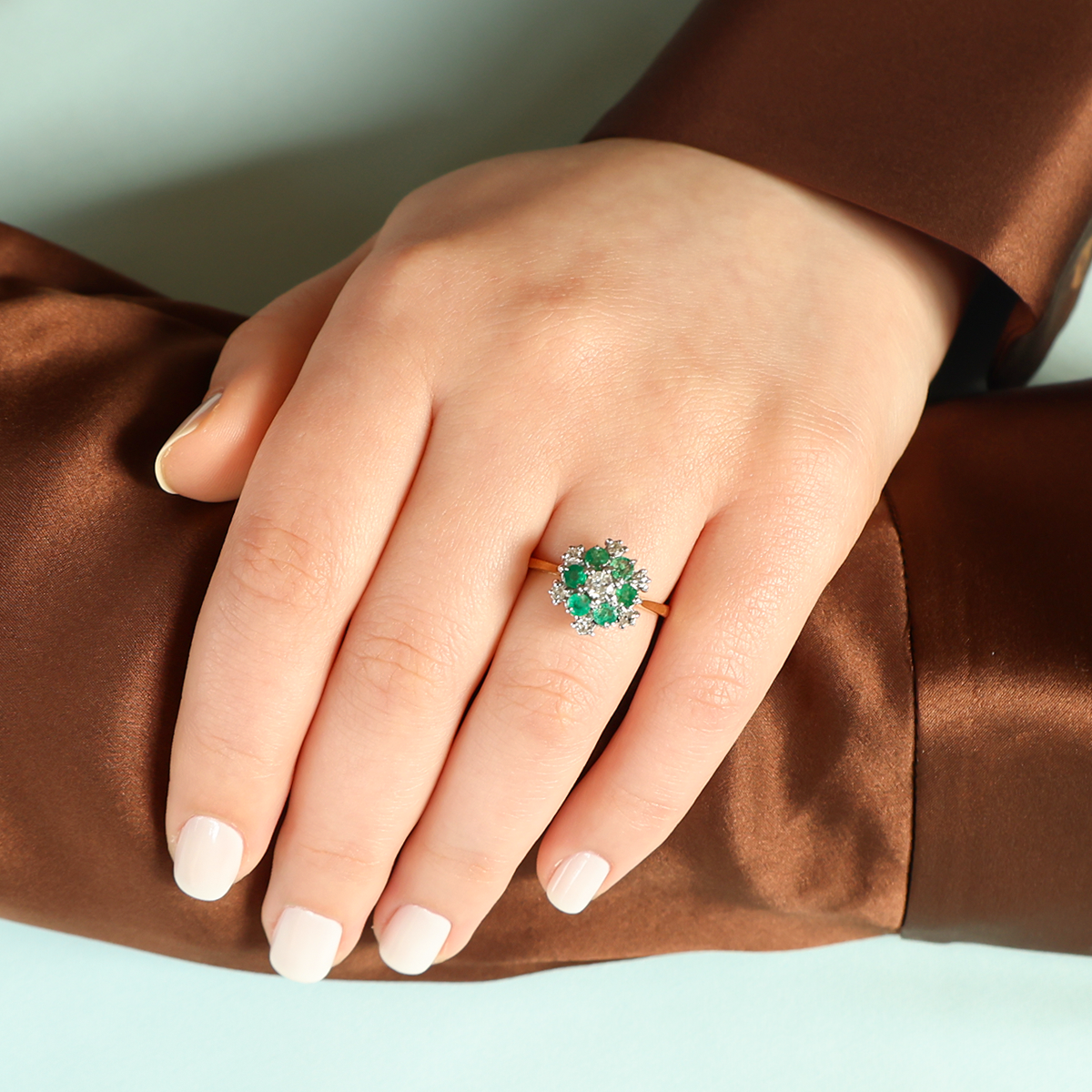 Model wears 18ct Yellow Gold Emerald & Diamond Snowflake Cluster Ring