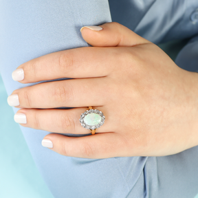 Model wears 18ct Yellow Gold Oval Shaped Opal & Diamond Cluster Ring