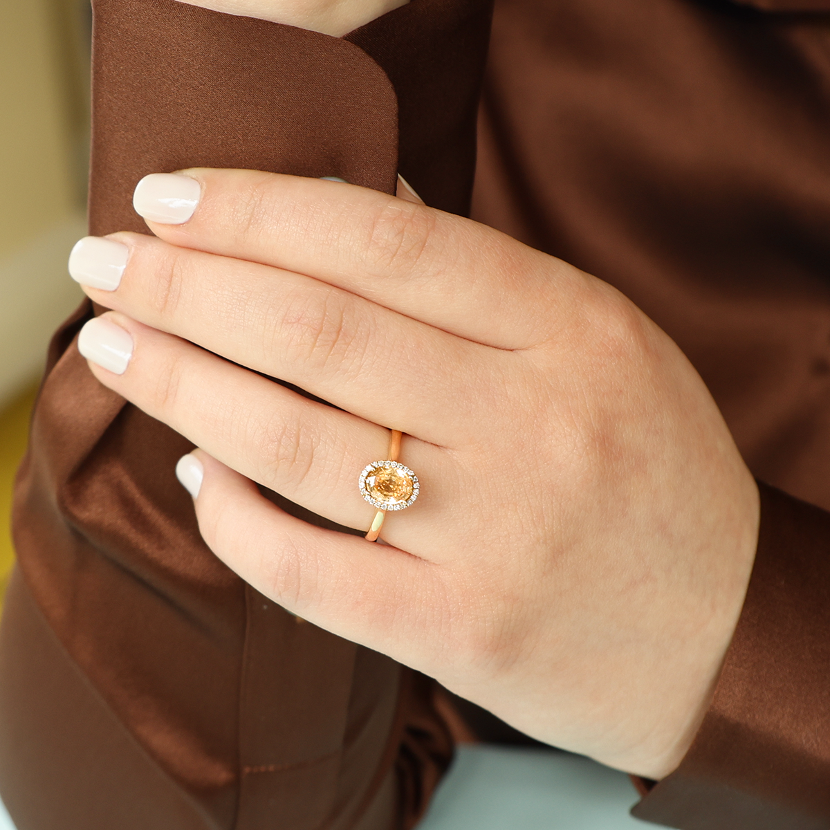 Model wears 18ct Yellow Gold Oval Shaped Peach Sapphire & Diamond Cluster Ring