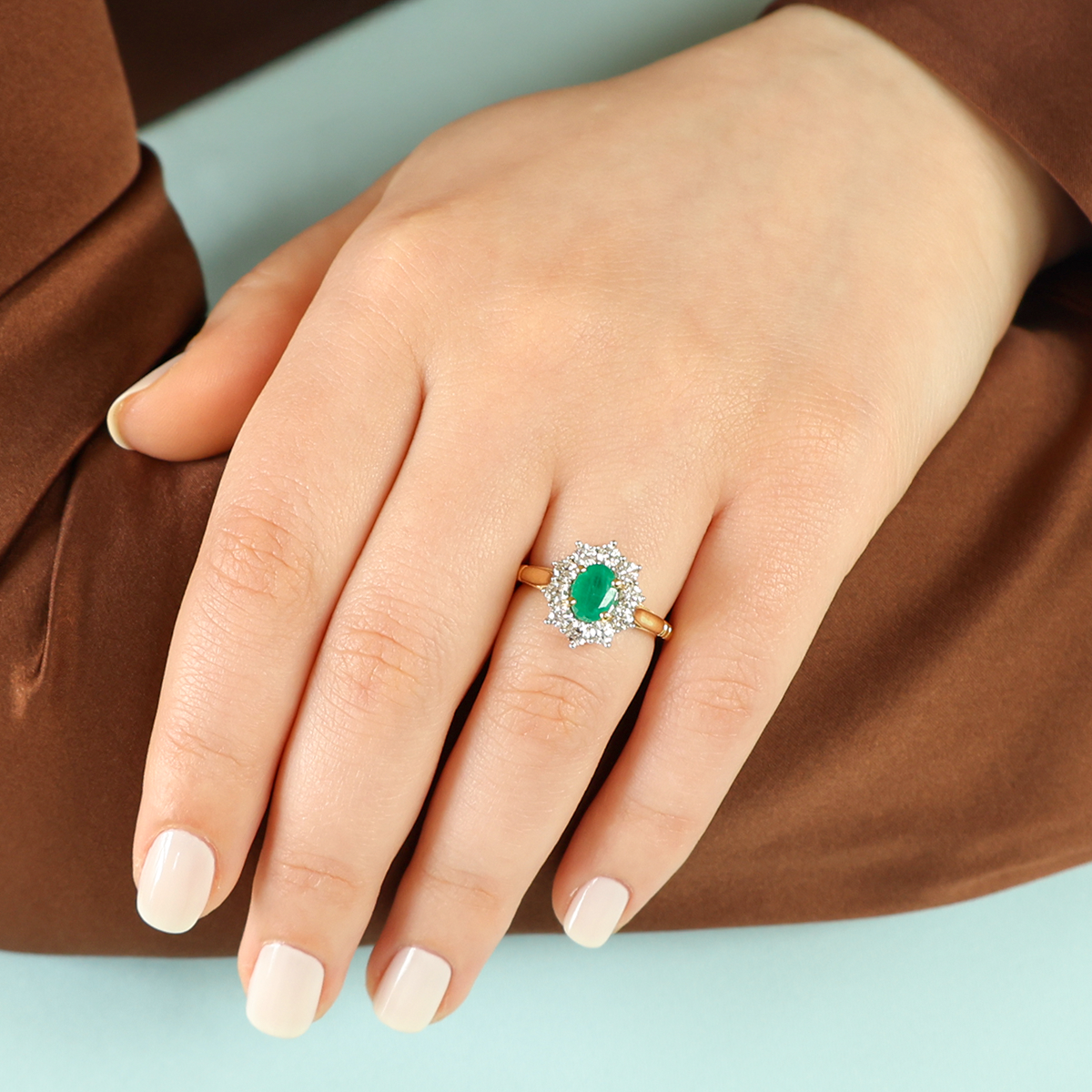 Model wears 18ct Yellow Gold Oval Shaped Emerald & Diamond Cluster Ring