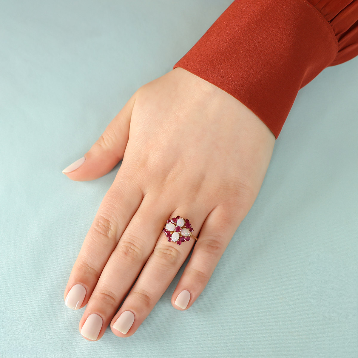 Model wears 9ct Yellow Gold Ruby & Opal Quatrefoil Cluster Ring