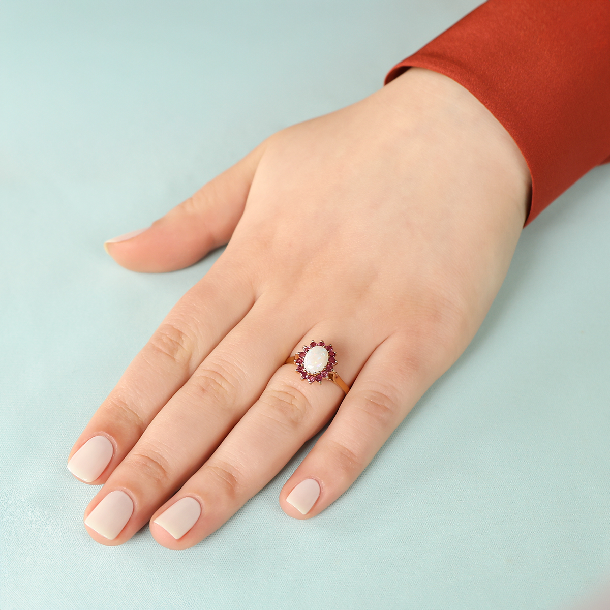 Model wears 9ct Yellow Gold Oval Shaped Opal & Ruby Cluster Ring