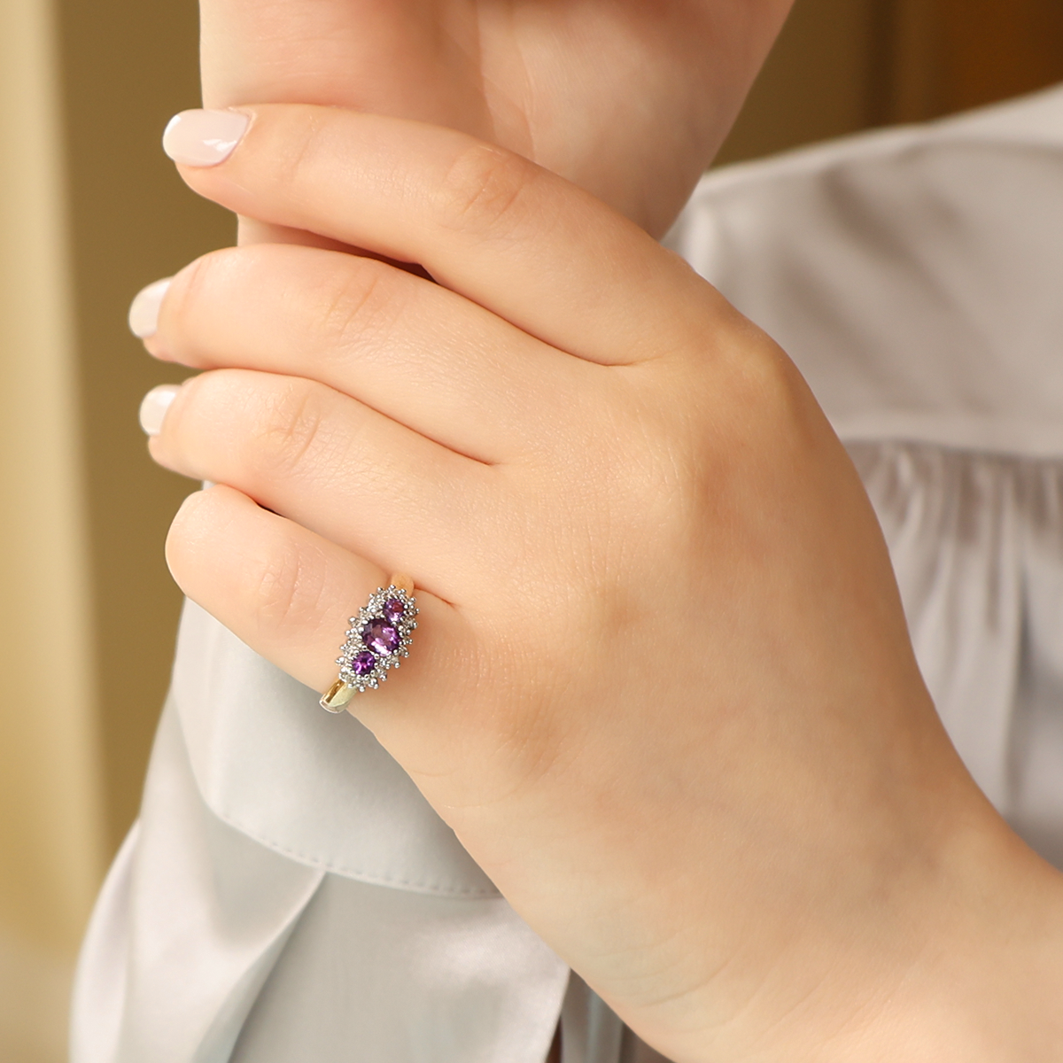 Model wears 9ct Yellow Gold Amethyst & Diamond Trilogy Cluster Ring