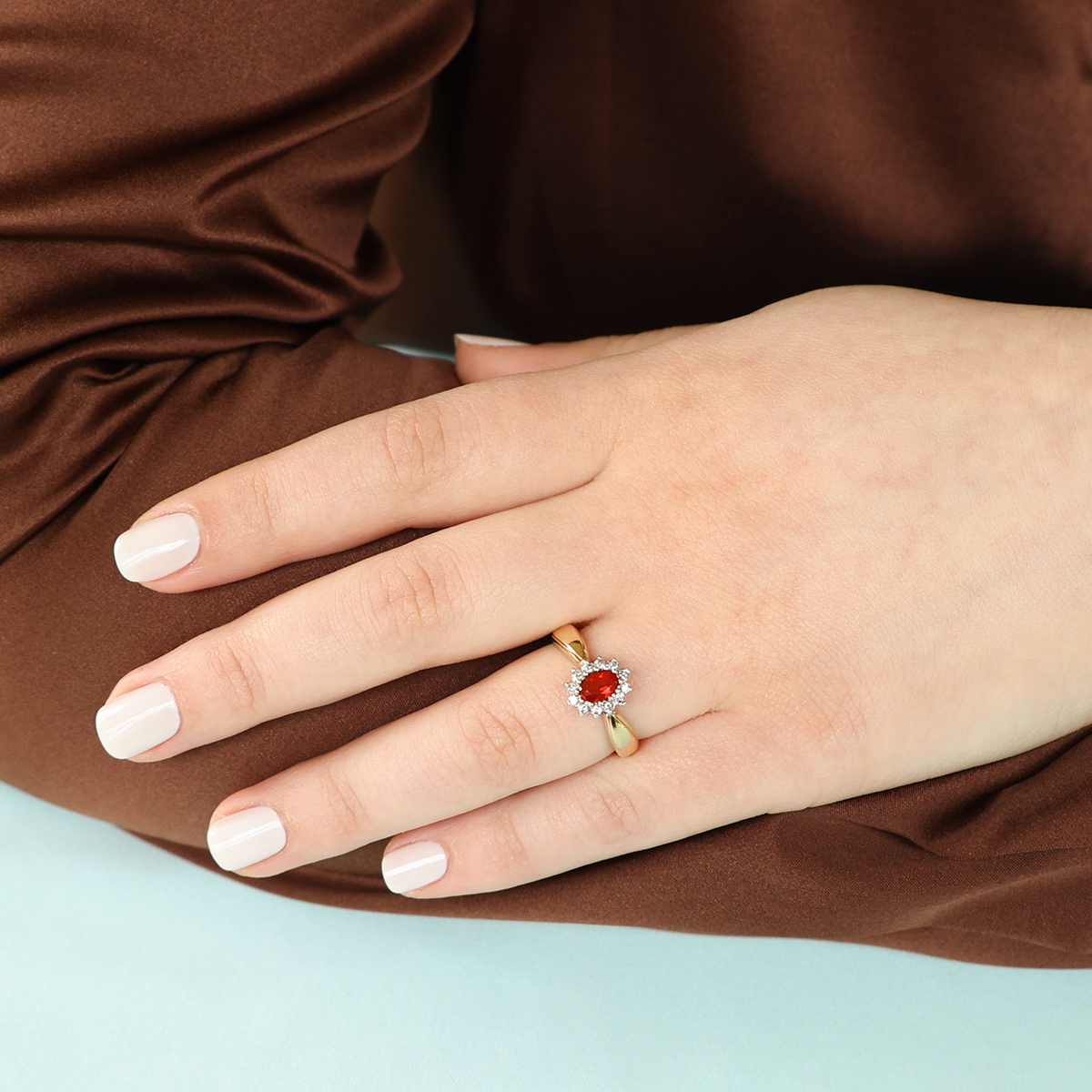Model wears 9ct Yellow Gold Oval Shaped Fire Opal & Diamond Cluster Ring