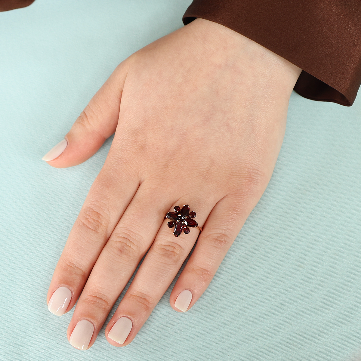 Model wears 9ct Yellow Gold Marquise & Round Cut Garnet Cluster Ring