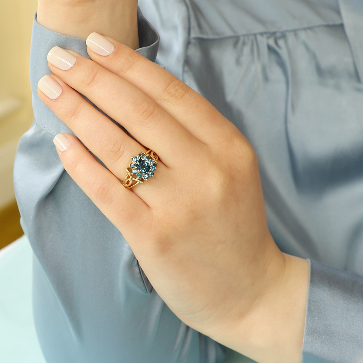Model wears 9ct Yellow Gold London Blue Topaz Cluster Ring