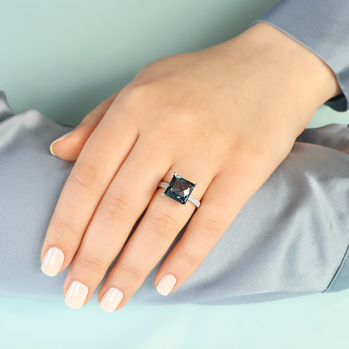 Model wears 9ct White Gold Square Cut London Blue Topaz & Diamond Cocktail Ring