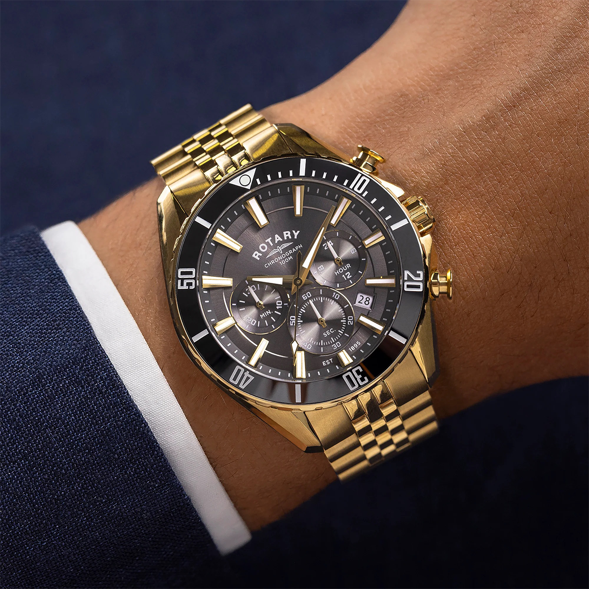 Model wears Rotary Apex 100 Chronograph, Black Dial with Gold Plated Bracelet RGB10014/04