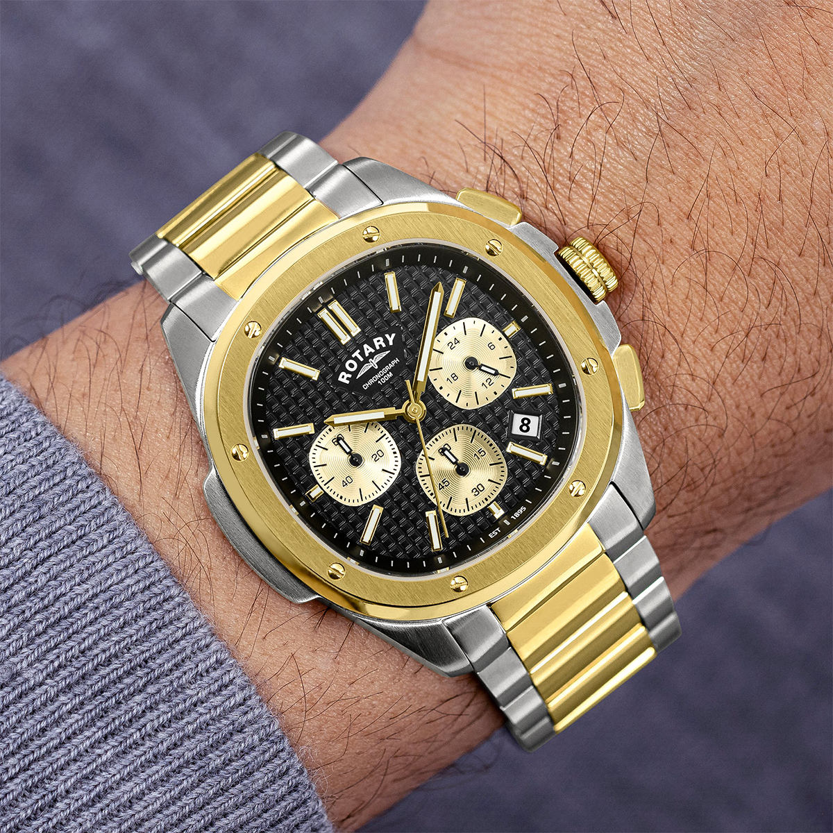 Model wears Rotary Apex 100 Chronograph 2-Tone Watch, Black Dial with Stainless Steel Bracelet RGB10032/04