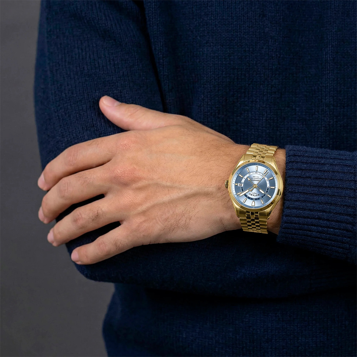 Model wears Rotary Seamatic 100 GMT Automatic, Light Blue Dial with Gold Plated Bracelet RGB10044/57