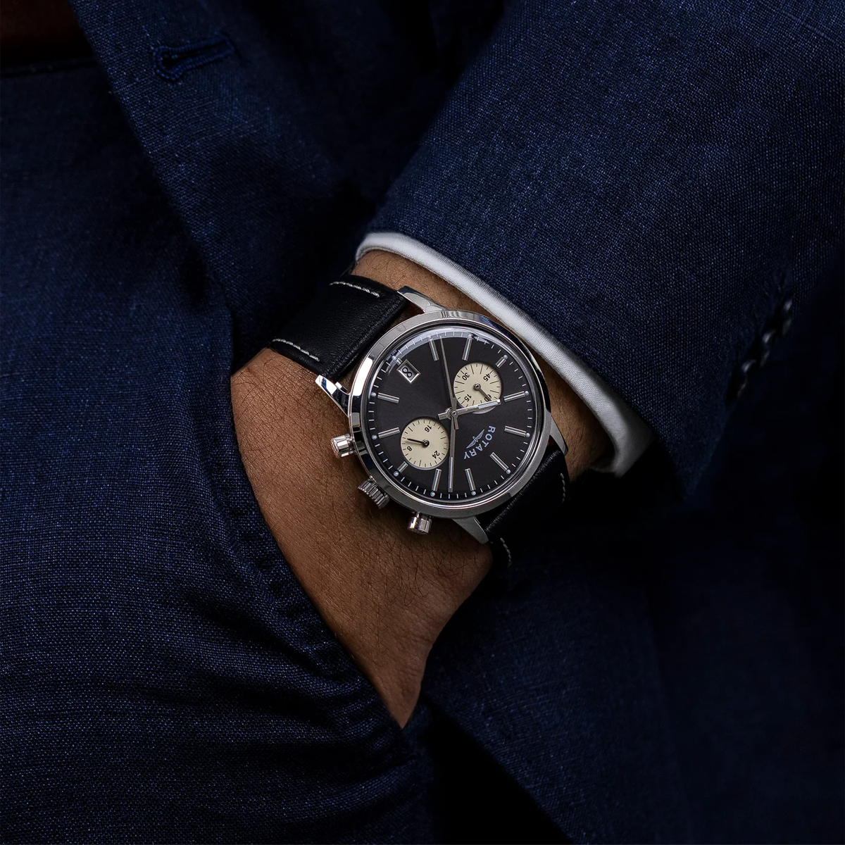 Model wears Rotary 1895 Chronograph, Black Dial with Black Leather Strap RGS10067/04