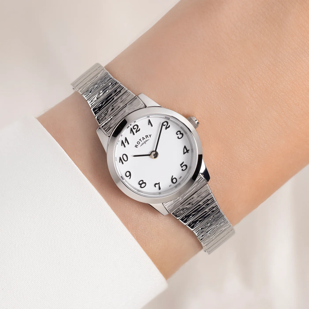 Model wears Rotary Heritage Altera, Round White Dial with Textured Stainless Steel Bracelet RLB10029/01