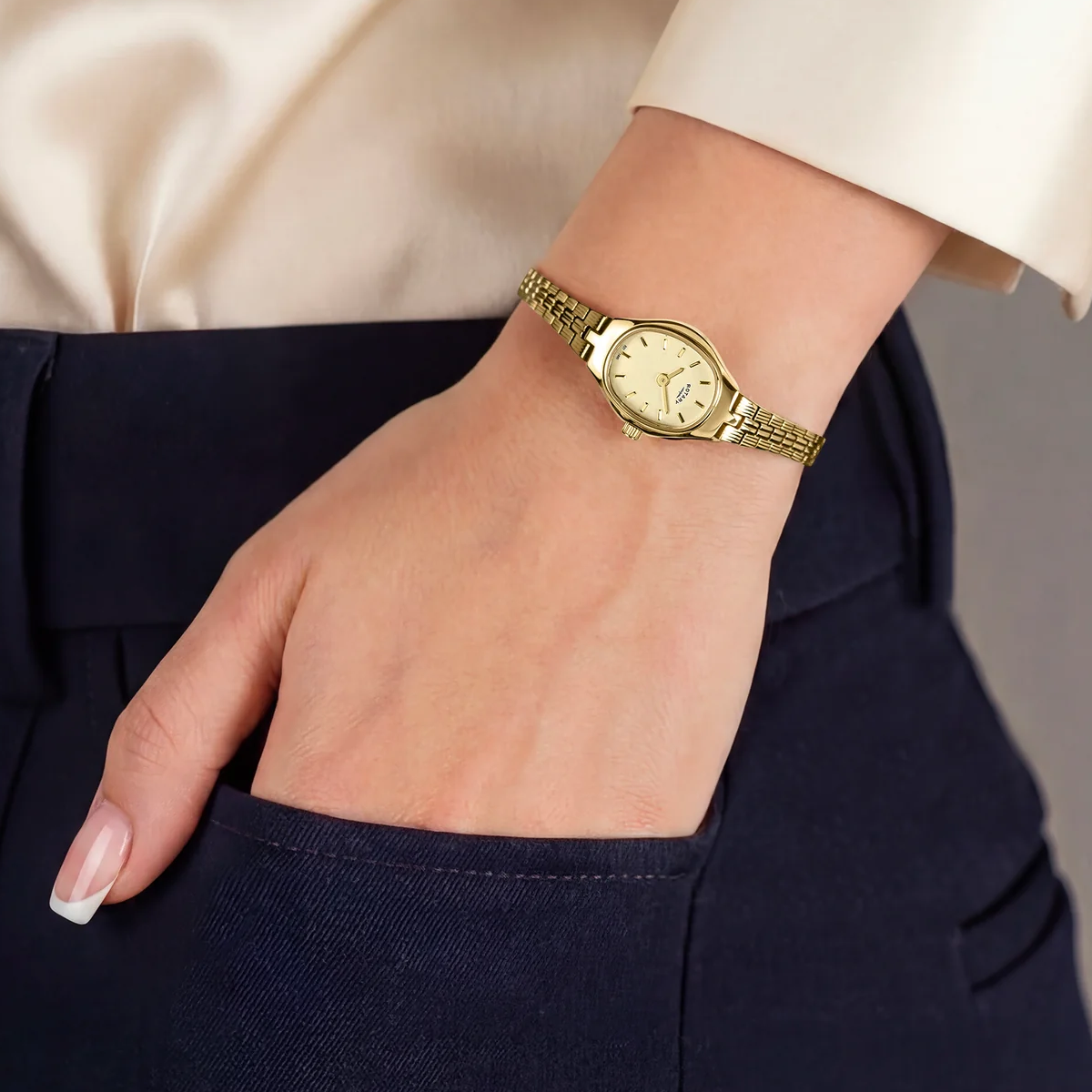 Model wears Rotary 1895, Champagne Oval Dial with Gold Plated Bracelet RLB10048/03