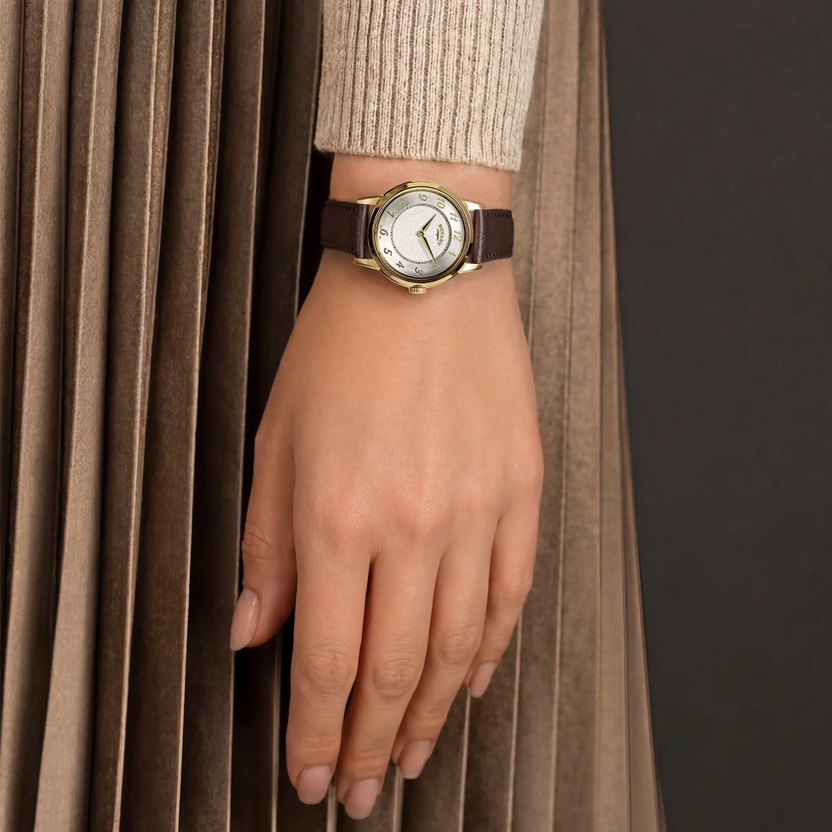 Model wears Rotary Heritage Ladies Gold Plated, White Dial with Brown Leather Strap RLS10054-41