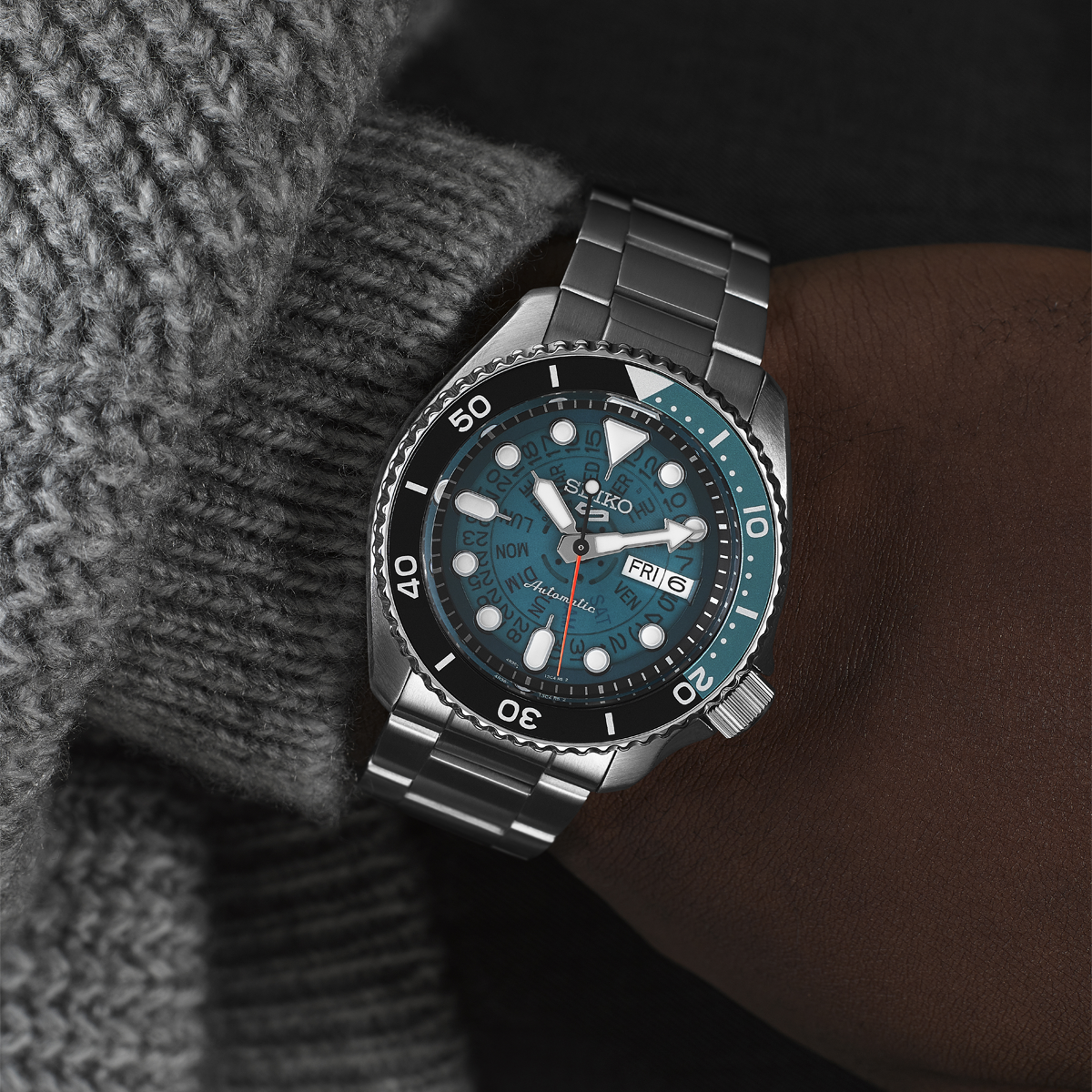 Model wears Seiko 5 Sports SKX 'Skeleton Style', Blue Dial with Stainless Steel Bracelet - SRPJ45K1
